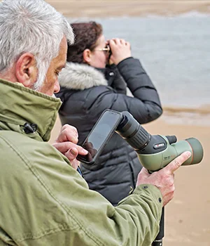 Birders using a Kowa spotting scope on the beach