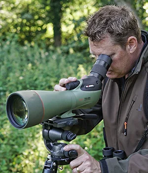 Man using a Kowa spotting scope on a tripod